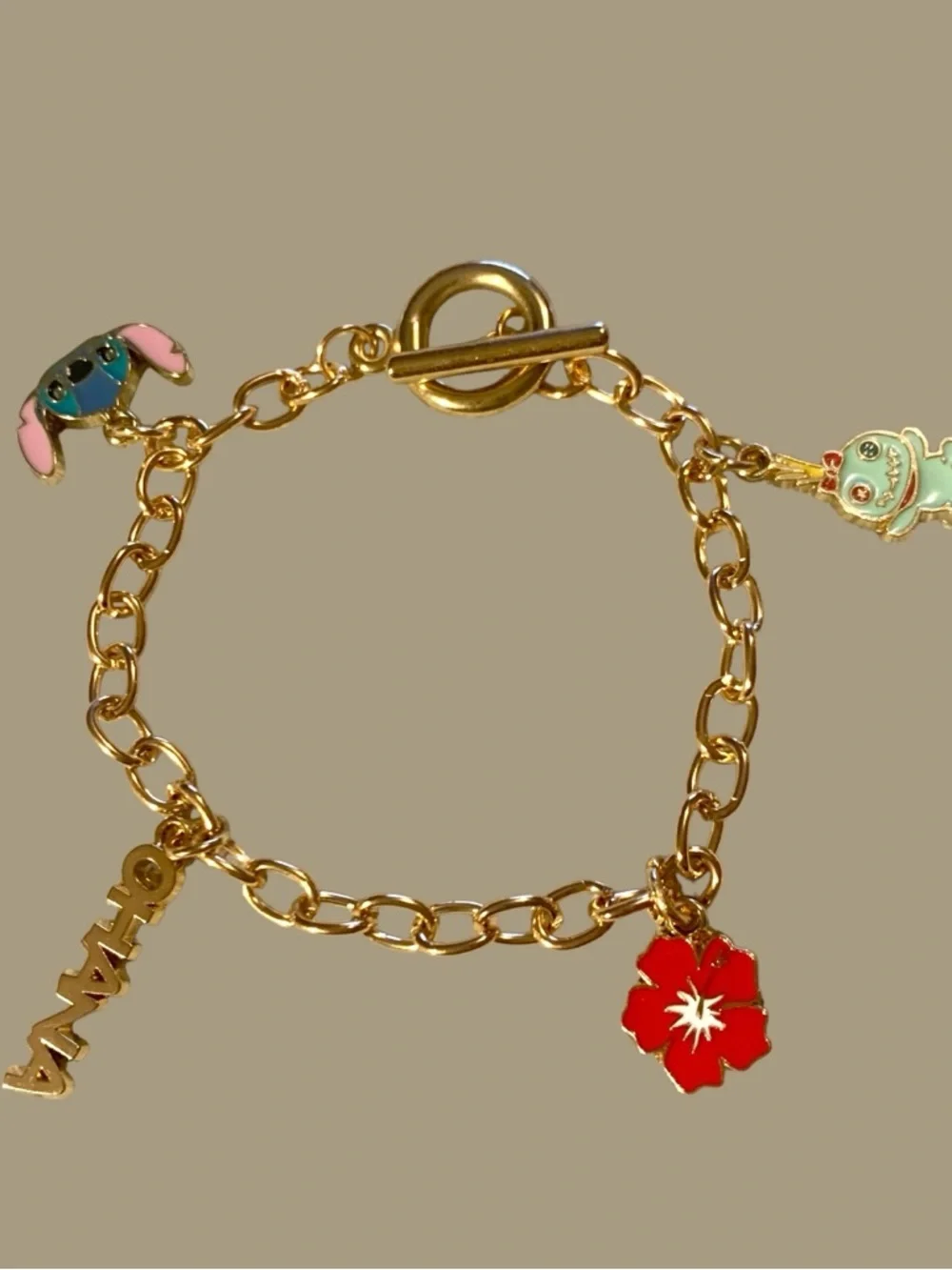 Gold Charm Bracelet with Blue Stitch and Red Flower Charms